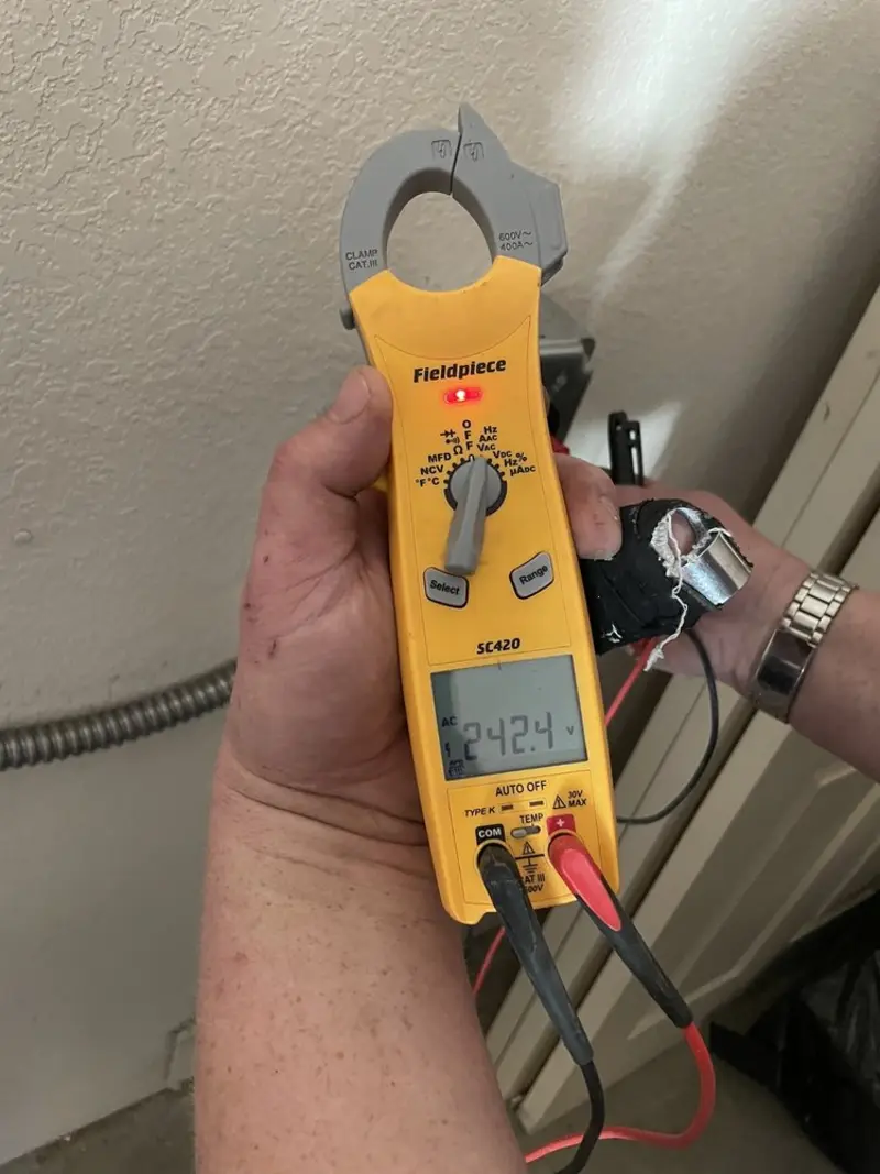 Voltage testing with clamp meter during Ceiling Fan Installation in Clinton